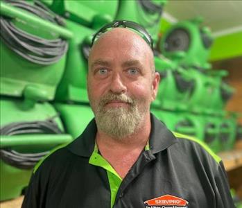 SERVPRO employee in front of a green background